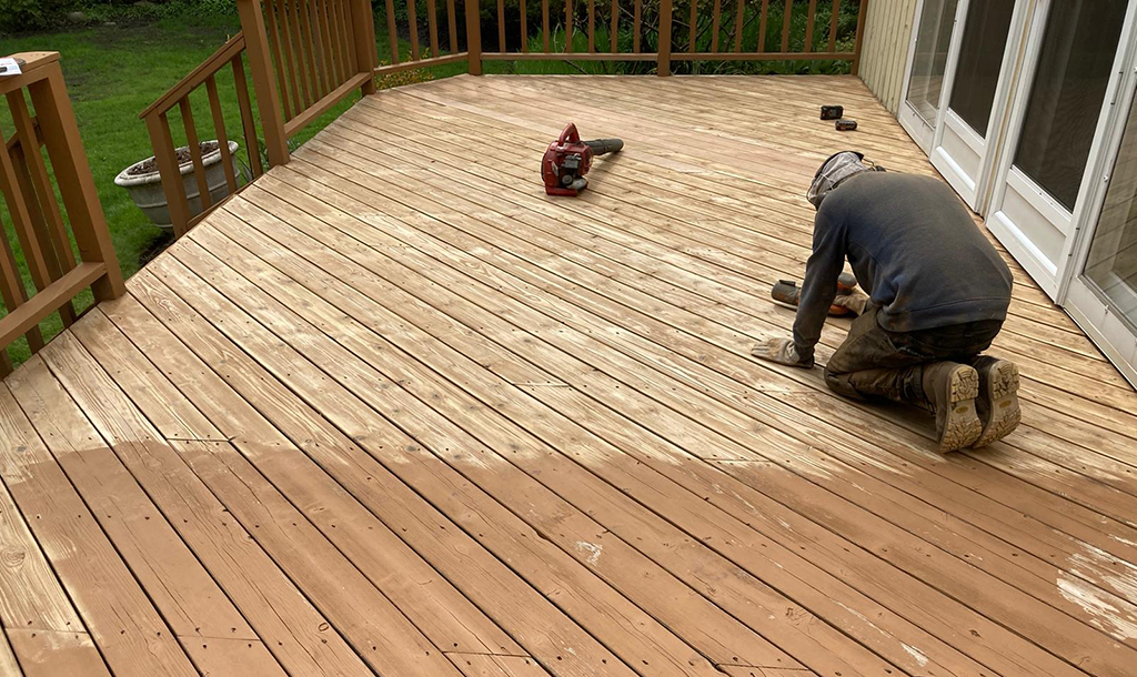 man preparing deck for staining 