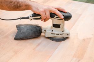 deck restoration with electric sander