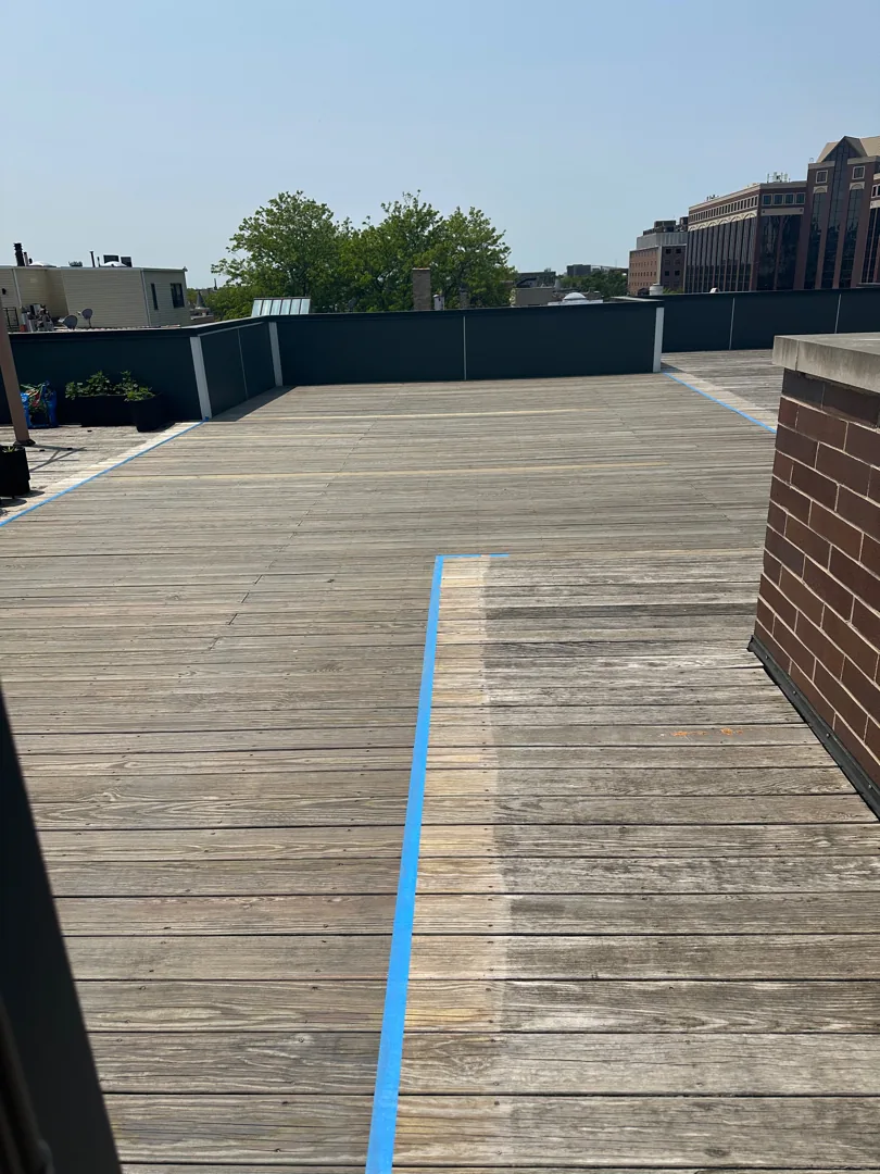Condo rooftop wood deck in Chicago after cleaning and a gray penetrating stain