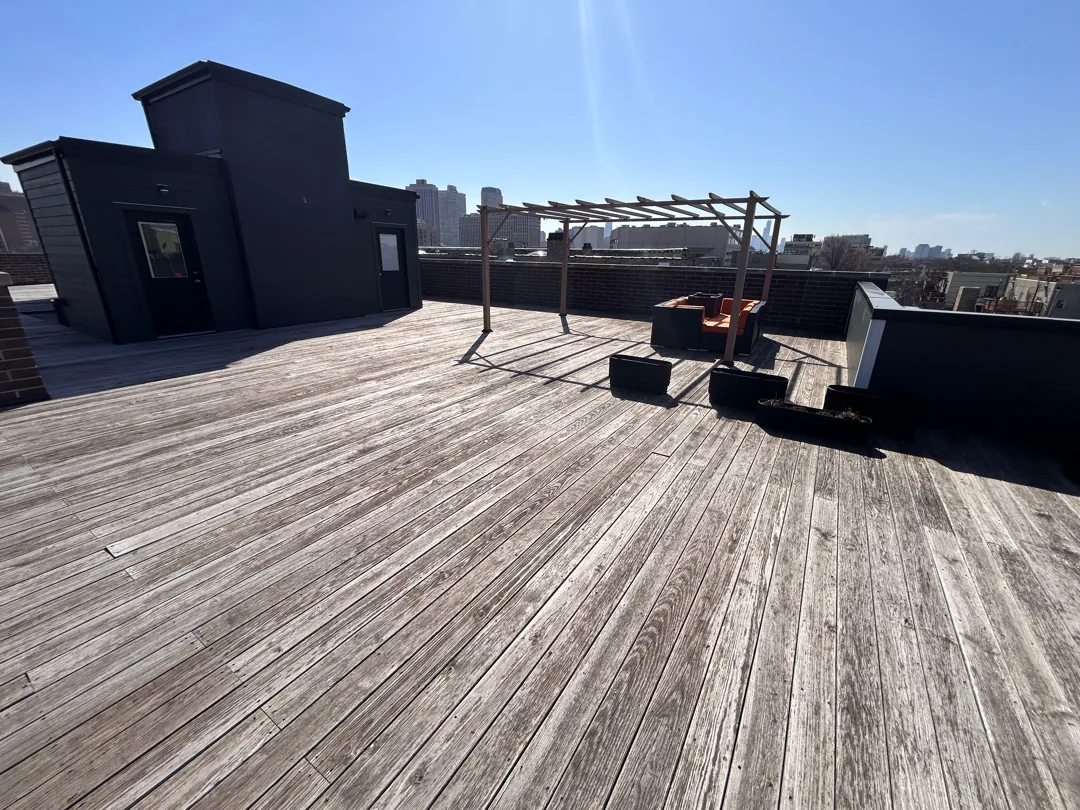 Condo rooftop wood deck in Chicago, gray and weathered before cleaning