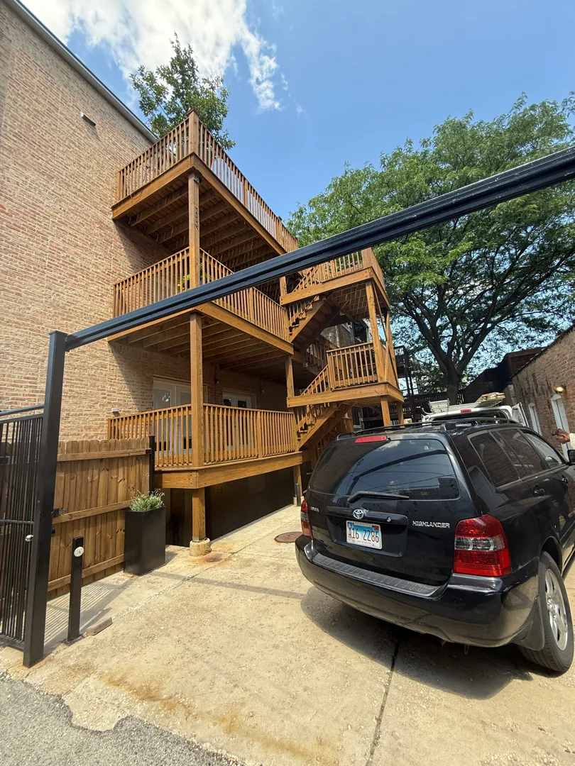 Restored three-story wood back porch on a Chicago multi-unit building