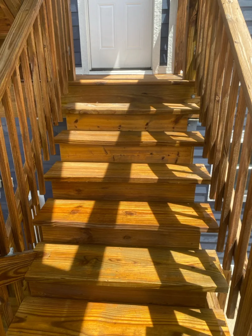 Cleaned and brightened wood porch stairs on a Chicago three-flat, ready for stain