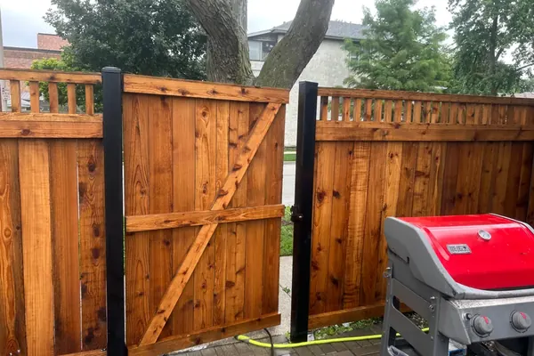 Restored cedar fence and gate stained warm brown in Oak Park, IL